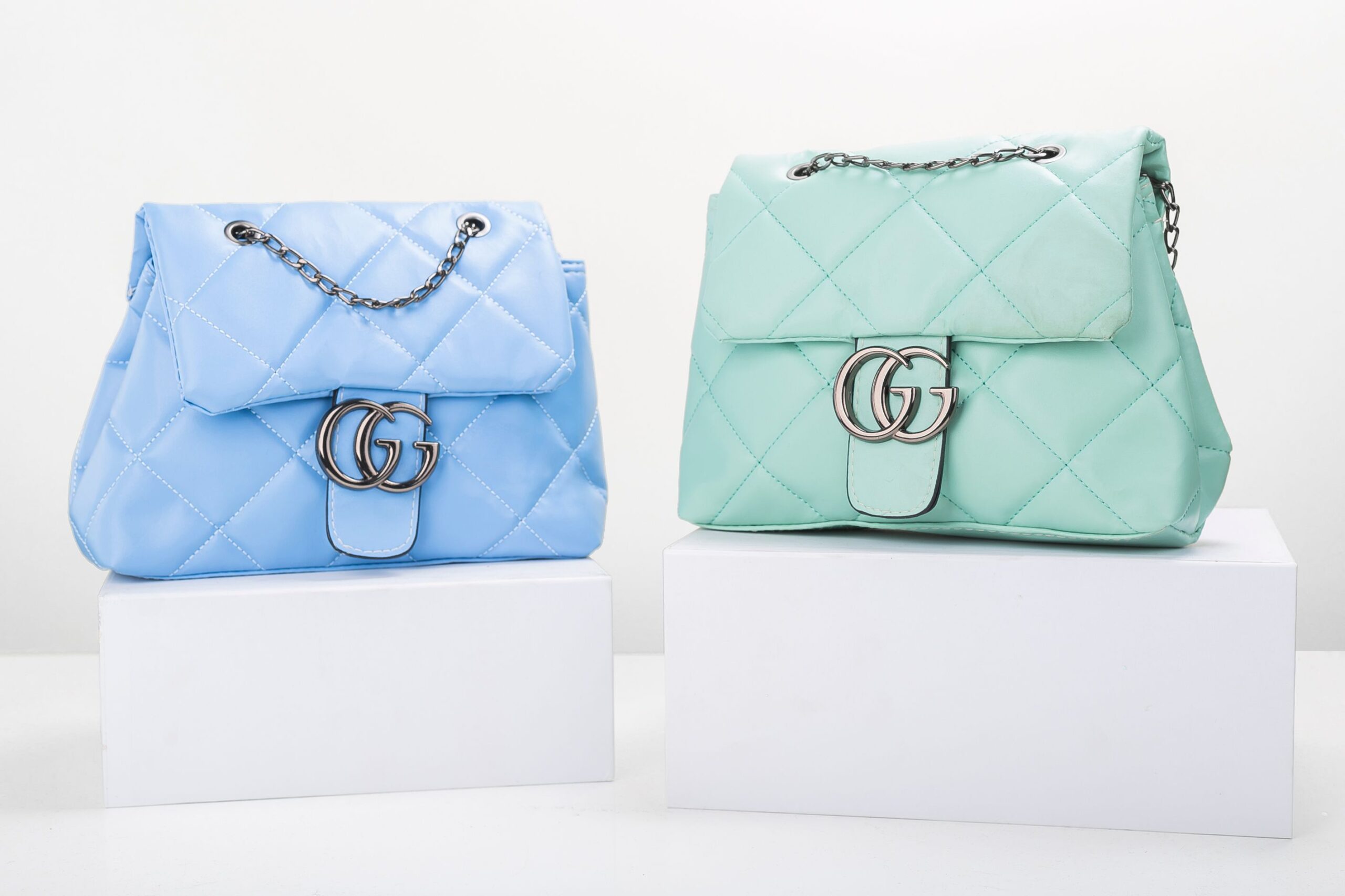 Stylish blue and mint quilted handbags on display, perfect for fashion enthusiasts.
